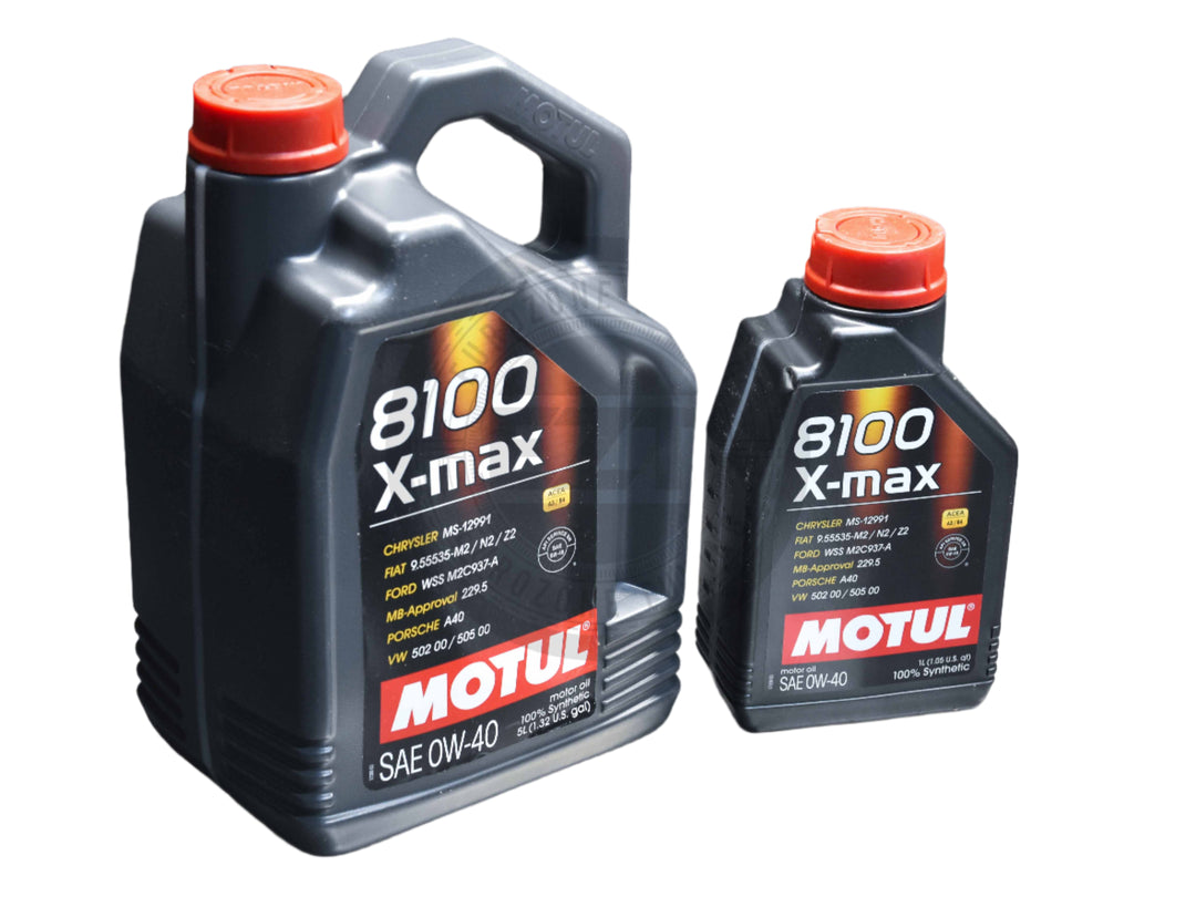 Two containers of Motul 8100 X-Max 0W-40 Gen 2 Engine Oil on a metal surface, with one larger container and one smaller container.