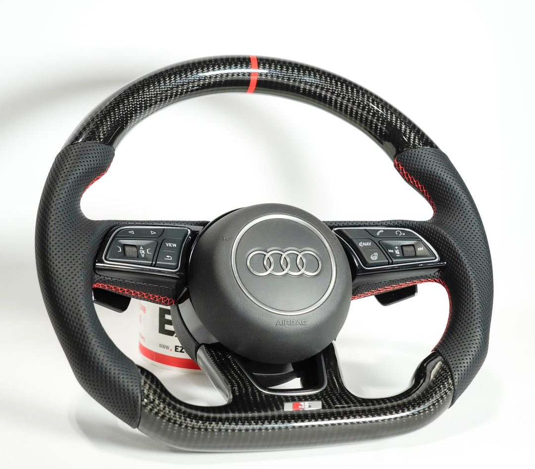 Carbon fiber steering wheel with Audi logo on a white background