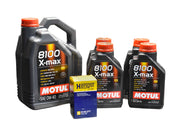 Multiple bottles of Motul 8100 X-Max 0W-40 engine oil and Hengst oil filters, positioned on a surface with Porsche vehicle models in the background.