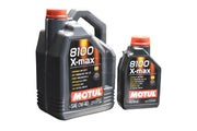 Two containers of Motul 8100 X-Max 0W-40 Synthetic Motor Oil, one in 5-quart size and a smaller 1-quart size, both with red caps, labeled for high performance in European vehicles.