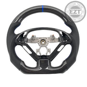 Carbon fiber steering wheel with metal center on a white background