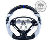 Load image into Gallery viewer, Carbon fiber steering wheel with white accents on a light blue background

