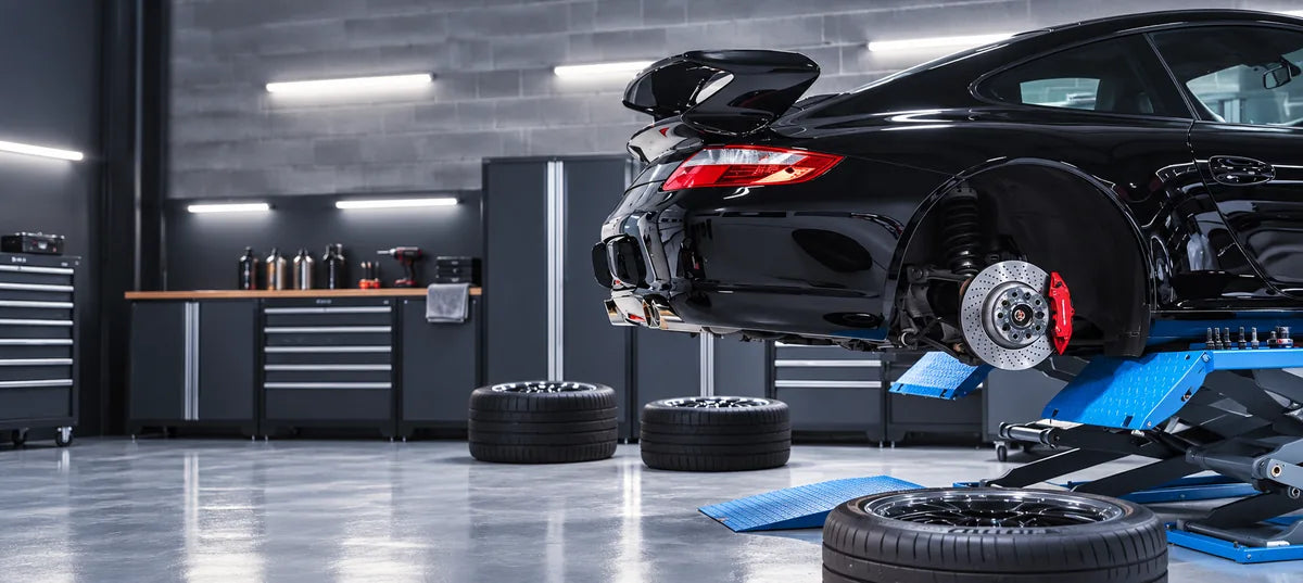 Performance car on a lift with its brake rotor and caliper exposed